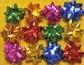 Festive colorful bows on sparkling glitter paper texture. Holiday background. Royalty Free Stock Photo