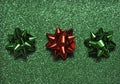 Festive colorful bows on sparkling glitter paper texture. Holiday background. Royalty Free Stock Photo