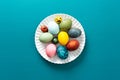 Festive, colorful eggs in various shades are neatly arranged on a decorative plate, symbolizing Easter traditions and Royalty Free Stock Photo