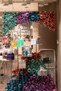 Festive Colourful Baubles in a Beauty Shop Window.