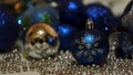 Festive composition with blue and silver christmas tree toys. Concept. Blinking blurred garland and beautiful small and Royalty Free Stock Photo