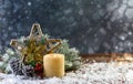 Festive composition with a Christmas star and a burning candle