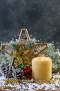 Festive composition with a Christmas star and a burning candle