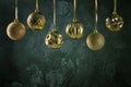 Festive composition with copy space. Gold-colored Christmas balls hanging by a ribbon. Royalty Free Stock Photo