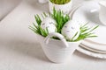Festive composition Easter eggs in glasses white dishes and willow tulips on a white table. Happy Easter concept. Royalty Free Stock Photo