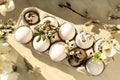 Festive composition with eggs and floral decor on windowsill indoors, flat lay. Happy Easter