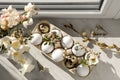 Festive composition with eggs and floral decor on windowsill indoors, flat lay. Happy Easter