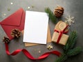 Festive composition featuring a blank white card on top of a tan envelope and a red envelope.AI Royalty Free Stock Photo