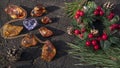 Festive composition of glittering natural pieces of Baltic amber, pine twigs and sparkling lilac heart shape crystal on the stump