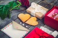 Festive composition with homemade cookies in shape of heart, rose flower, gift box. card with envelope, vintage ribbon. Gift for l Royalty Free Stock Photo