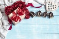 Festive composition for Valentine`s Day with a gift box, knitted element and decorative word love Royalty Free Stock Photo