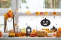 Festive decor of the house on the windowsill for Halloween - pumpkins, Jack o lanterns, skulls, cobwebs, spiders, skeletons, Royalty Free Stock Photo