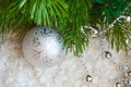 Decor for a happy Christmas and New year. Silver color. Christmas balls and beads on a white cozy blanket. happy winter holidays.