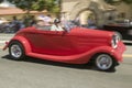 Festive decorated antique automobile makes its way down main street during a Fourth of July parade in Ojai, CA