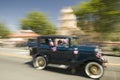 Festive decorated antique automobile makes its way down main street during a Fourth of July parade in Ojai, CA