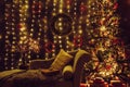 Festive decorated home Christmas interior living room in with lot of string LED lights. Royalty Free Stock Photo