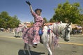 Festive decorated horse and rider make their way down main street during a Fourth of July parade in Ojai, CA