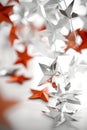 Festive Decoration Array of Red and Silver Origami Stars Hanging on a White Background