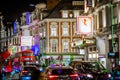 Festive decorations and Christmas lights at Leicester square and people walking on the street. London`s night life