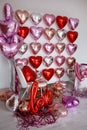 Festive decorations for Valentine's day, wedding or hen party. Love sign and heart shape balloons on white Royalty Free Stock Photo