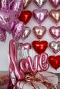 Festive decorations for Valentine's day, wedding or hen party. Love sign and heart shape balloons on white Royalty Free Stock Photo