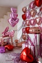 Festive decorations for Valentine's day, wedding or hen party. Love sign and heart shape balloons on white Royalty Free Stock Photo