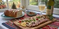 Festive dinner featuring sliced meat, bread, and wine with holiday decorations in cozy setting Royalty Free Stock Photo