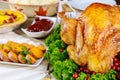 Festive dinner table served with turkey, decorated with kale and cranberry Royalty Free Stock Photo