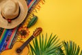 Celebrating Cinco De Mayo: Colorful Mexican Serape and Sombrero With Guitar on a Yellow Background
