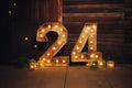 A festive display of the number 24 composed of Christmas trees, surrounded by the cheerful glow of holiday lights Royalty Free Stock Photo