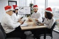 Festive diverse group of multiracial business people in conference room with big TV screen Royalty Free Stock Photo