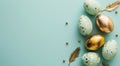 Festive easter background with painted golden decoration on easter eggs on turquoise table. Top view and fashion flat lay