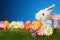 Festive Easter background with rabbit, flowers, and colorful egg