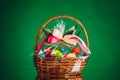 festive Easter basket with colorful eggs, green background