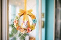 festive easter bunny wreath hanging on a front door Royalty Free Stock Photo