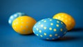 Festive Easter Composition Blue and Yellow Polka Dot Eggs on Vibrant Blue Background Royalty Free Stock Photo
