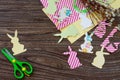 Festive Easter decor with handmade decoration of colorful rabbits on a wooden background.