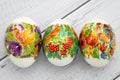 Festive easter gift card. Colorful eggs on wooden white background. Paschal decoration