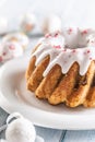 Festive easter marble cake with icing sugar with hand-decorated eggs