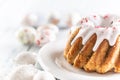 Festive easter marble cake with icing sugar with hand-decorated eggs