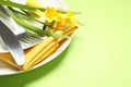 Festive Easter table setting with narcissuses, closeup. Space for text Royalty Free Stock Photo
