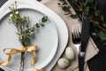 Festive Easter table setting with eggs and floral decoration on background, flat lay Royalty Free Stock Photo