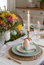 Easter table setting with candle and flowers Royalty Free Stock Photo