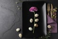 Festive Easter table setting with quail eggs and floral decoration on background, flat lay Royalty Free Stock Photo