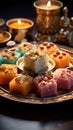 Festive ensemble Group of Indian mithai sweets adorned with a decorative diya Royalty Free Stock Photo