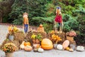 Festive fall decor with scarecrows, pumpkins, mums and hay bales. Royalty Free Stock Photo