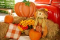 Festive fall farm scene with pumpkins and scarecrows