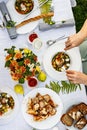 A festive family dinner or barbecue in the summer garden. Family leisure and celebration and food concept. People are eating Royalty Free Stock Photo