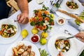 A festive family dinner or barbecue in the summer garden. Family leisure and celebration and food concept. People are eating Royalty Free Stock Photo