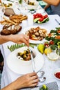 A festive family dinner or barbecue in the summer garden. Family leisure and celebration and food concept. People are eating Royalty Free Stock Photo